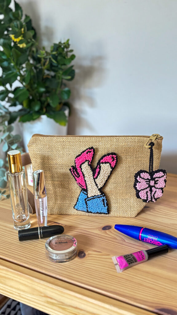 Summer-themed punch needle embroidery pattern with warm terracotta, cream, and sage green stitches on a canvas clutch or small bag